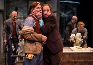 A jealousy-crazed Master Ford (Ross Lehman, right) clutches at the unsuspecting Master Page (Kevin Gudahl) in Chicago Shakespeare Theater’s production of The Merry Wives of Windsor, directed by Artistic Director Barbara Gaines.