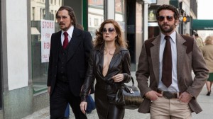Christian Bale, Amy Adams and Bradley Cooper in Columbia Pictures' AMERICAN HUSTLE