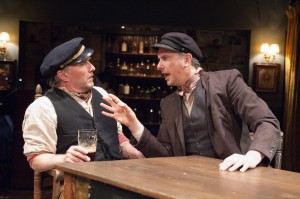 "Captain" Jack Boyle (Ron Rains, left) and his friend "Joxer" Daly (James Houton) argue their days away at the pub rather than spending them at work in TimeLine Theatre's Chicago premiere production of the musical JUNO, book by Joseph Stein, music and lyrics by Marc Blitzstein, based on the play Juno and the Paycock by Sean O'Casey, directed by Nick Bowling with music direction by Doug Peck and Elizabeth Doran, presented at TimeLine Theatre, 615 W. Wellington Ave., Chicago, April 23 - July 27, 2014.