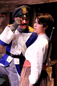 Polly Perks (Sarah Price, right) is harassed by an enemy officer (Matt Engle, Left) in Lifeline Theatre’s world premiere production of “Monstrous Regiment,” adapted by Chris Hainsworth, directed by Kevin Theis, based on the novel by Terry Pratchett.