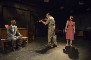 Manny Buckley, Brad Woodard and Angie Shriner in Shattered Globe Theatre’s production of IN THE HEAT OF THE NIGHT, adapted by Matt Pelfrey, based on the novel by John Ball and directed by Louis Contey. Photo by Michael Brosilow.