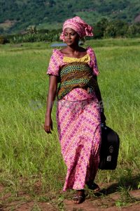 Actress Essuman (Rukiyat Masud) walking through a grassland in a scene shot in the Volta Region of Ghana. From the film CHILDREN OF THE MOUNTAIN. Photo by Selasie Djameh.