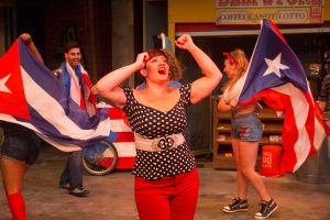 Missy Aguilar as "Daniela" and the cast of In The Heights perform "Carnaval Del Barrio"