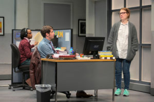 Gloria (Lauren English, right) stops by the desk of Dean (Jeremy Kahn) while the intern, Miles (Jared Corbin), watches in Branden Jacobs-Jenkins’s Gloria, performing at A.C.T.’s Strand Theater now through Sunday, April 12, 2020. Photo: Kevin Berne