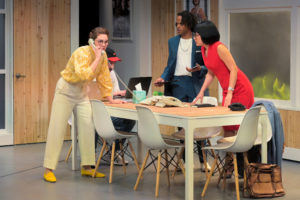 Callie (Martha Brigham) receives the call that a client has arrived at the office while Rashaad (Jared Corbin) and Jenna (Melanie Arii Mah) listen in Branden Jacobs-Jenkins’s Gloria, performing at A.C.T.’s Strand Theater now through Sunday, April 12, 2020. Photo: Kevin Berne