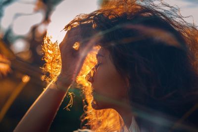 Mood photography concept: Profile of young woman at sunset