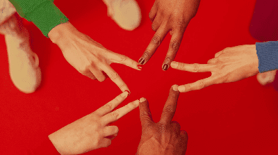 Five hands forming a star shape against a red background.