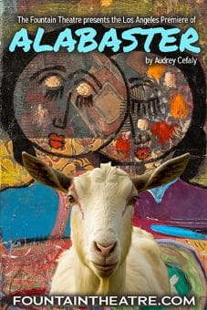 A goat stands in front of colorful, abstract wall art.