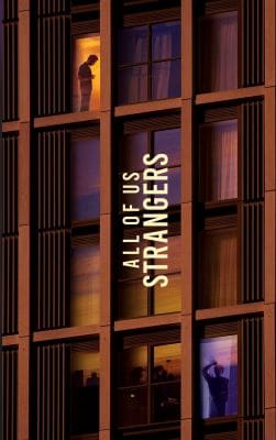 A building facade with the text "ALL OF US ARE STRANGERS" displayed vertically.