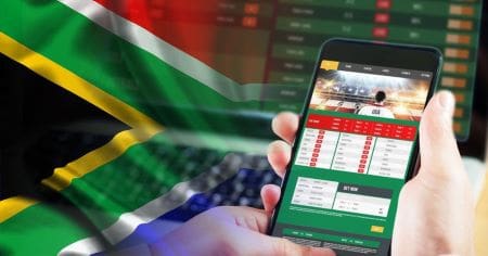 Person using a sports betting app with a South African flag in the background.