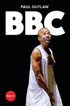 A man in a white tank top performing on stage under BBC lighting.
