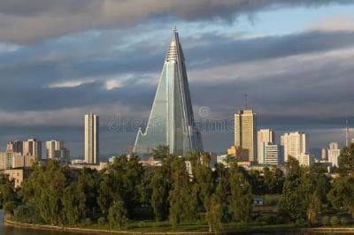 The Shard skyscraper towering over London with a cloudy sky.