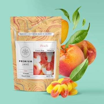 Peach-flavored herbal tea packaging with fresh peaches and leaves.
