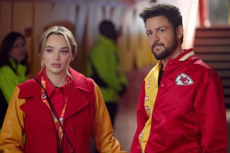Two people in red and yellow jackets looking at the camera.