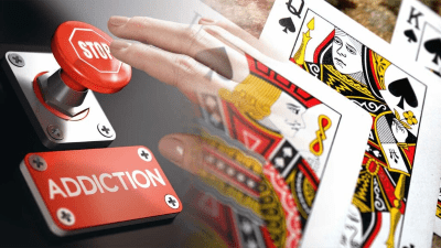 Hand holding playing cards with a red 'Addiction' button nearby.