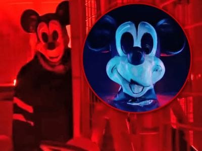 Eerie Mickey Mouse masks glowing under red and blue lights.