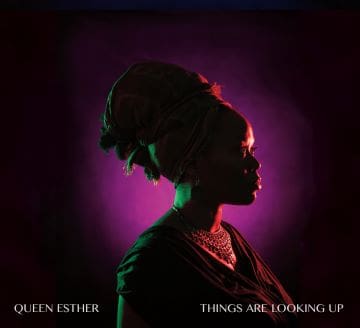 Silhouette of a woman against a purple-lit background, evoking strength and contemplation.