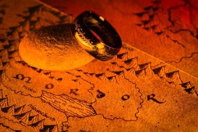 A ring resting on a detailed, old map under warm light.
