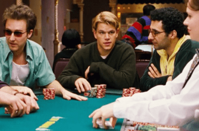 Young man focused while playing poker at a casino table.