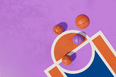 Four basketballs of different sizes on a colorful court.