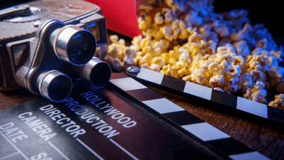 Clapperboard and popcorn ready for a movie night.