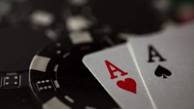 Ace of hearts card with poker chips in the background.