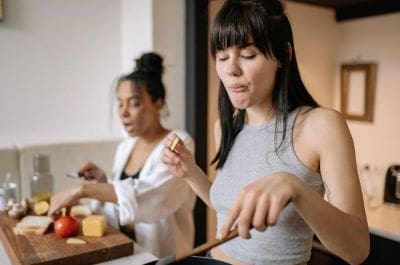 Two women cooking together in a kitchen.