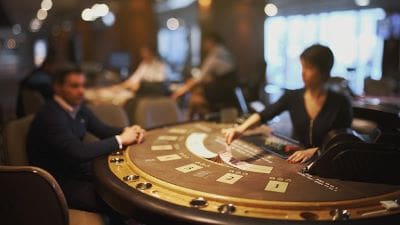 People playing blackjack at a casino table.
