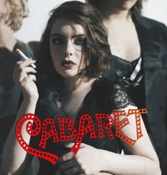 A woman in dramatic makeup poses with the word 'Cabaret' in red lights.
