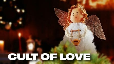A delicate angel ornament with curly hair and wings.