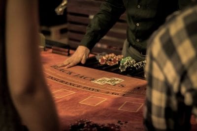 A hand interacts with a Ouija board during a session.