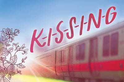 A subway train with the word 'KISSING' in bold pink letters above it.