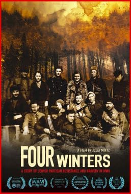Group photo of people dressed in early 20th-century attire in a forest setting.