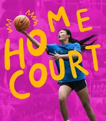 A female basketball player prepares to shoot on a vibrant pink and yellow background.