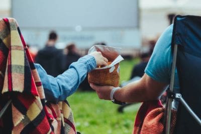 People exchanging money for food at an outdoor event.