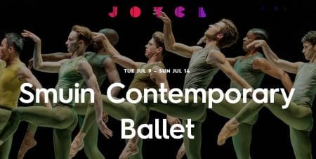 Contemporary ballet dancers perform on stage with dynamic movements.