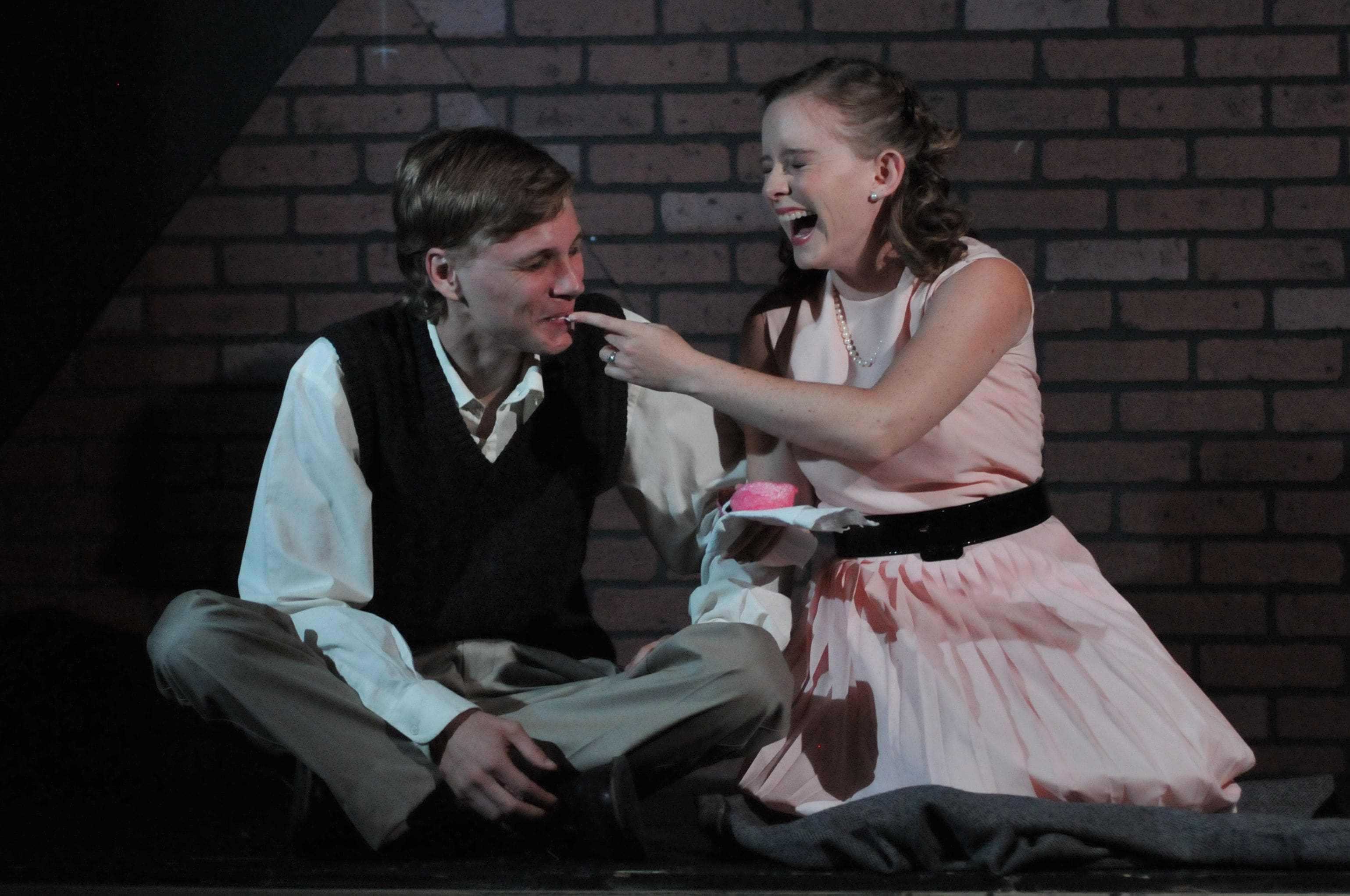 Julia by Vince Melocchi Young man and woman laughing together, sitting on steps.