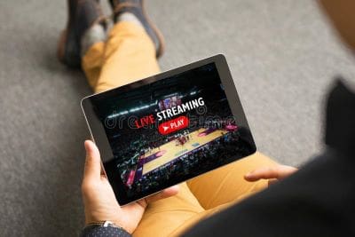 Person watching basketball live stream on a tablet.