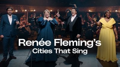 Renée Fleming and a male singer performing with an orchestra.