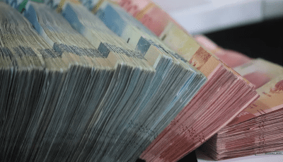 Stacks of various currency bills arranged closely together.