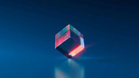 A glowing translucent cube floating against a dark blue background.