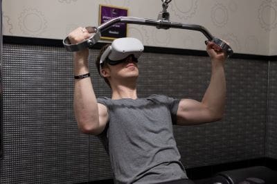 Man using VR headset while exercising in a gym.