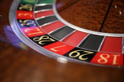 Close-up of a roulette wheel with colorful numbered slots.