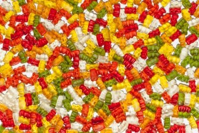 Close-up of colorful gummy bears scattered together.