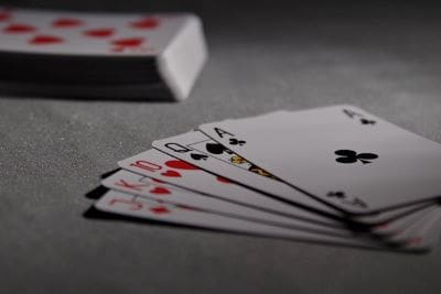 A fan of playing cards spread out on a table.