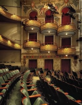 Interior of an ornate theater with balconies and seating.