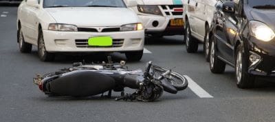 A motorcycle lying on its side after an accident on the road.