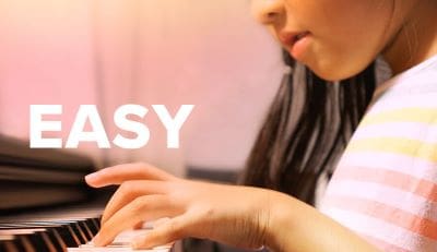 A person typing on a laptop keyboard with a blurred background.