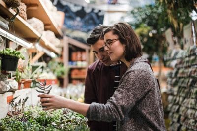 Two people enjoying a drink outdoors in a relaxed setting.