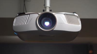 Close-up of a ceiling-mounted projector lens.